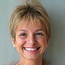 Portrait of Evelyn, 58, smiling.