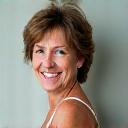 Portrait of Maria, 55, smiling thoughtfully.